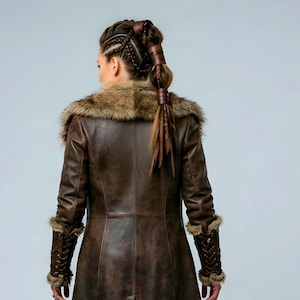 Women’s brown Viking leather fur coat costume featuring a dramatic fur-trimmed collar, long medieval warrior silhouette, fitted waist, front metal closures, leather belt, matching pants, wrist guards, and lace-up boots. Handmade Shieldmaiden-inspired outfit for Halloween, Viking cosplay, LARP events, Renaissance fairs, medieval festivals, fantasy conventions, Norse-themed parties, winter events, stage performances, warrior photoshoots, and custom made-to-measure costume styling for cosplay fans