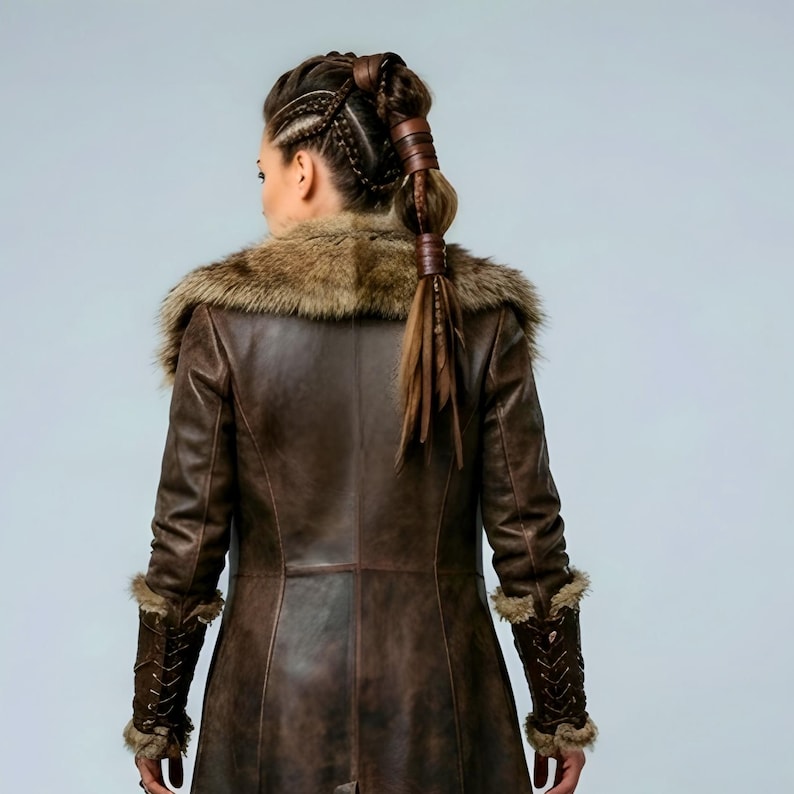 Women’s brown Viking leather fur coat costume featuring a dramatic fur-trimmed collar, long medieval warrior silhouette, fitted waist, front metal closures, leather belt, matching pants, wrist guards, and lace-up boots. Handmade Shieldmaiden-inspired outfit for Halloween, Viking cosplay, LARP events, Renaissance fairs, medieval festivals, fantasy conventions, Norse-themed parties, winter events, stage performances, warrior photoshoots, and custom made-to-measure costume styling for cosplay fans