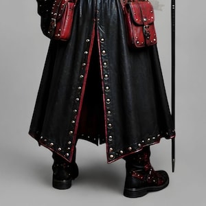 Black leather plague doctor costume coat with gothic and steampunk styling, red leather details, layered shoulder armor, straps, rivets, long sleeves, gloves and matching bracers. Dark fantasy medieval inspired cosplay outfit for Halloween, LARP, Renaissance fairs, photoshoots, festivals and costume parties. Handmade leather outerwear with a dramatic plague doctor aesthetic and customizable fit. Hat, plague doctor mask, bags, staff and accessories are not included and can be ordered separately.!
