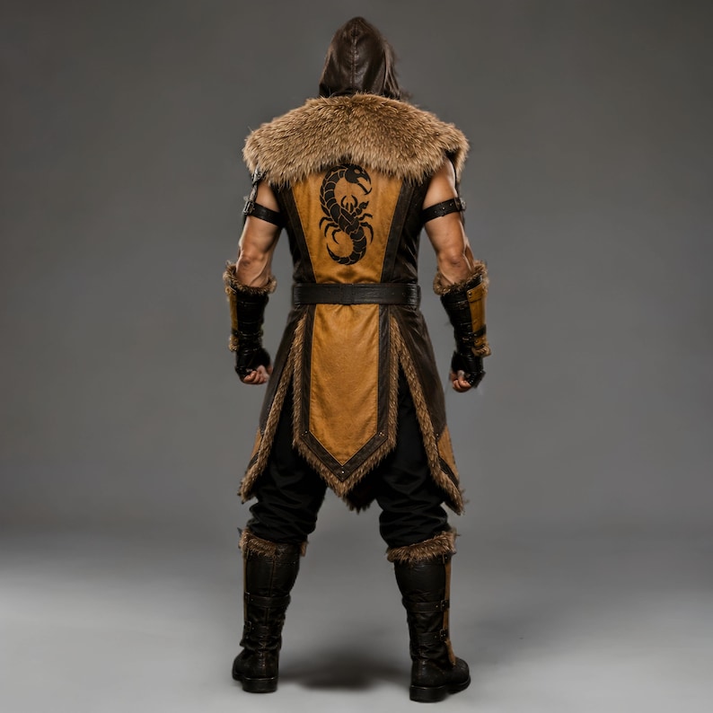 Black leather Viking ninja armor costume with antique gold leather panels, fur-trimmed shoulders, deep hood, adjustable waist belt, layered front armor, matching leather arm bracers, wrist guards and lower leg armor. Handmade medieval fantasy outfit with a rugged warrior-inspired design, suitable for Halloween, LARP, cosplay, Renaissance fairs, conventions, themed parties and fantasy photoshoots. Custom sizing and color options available.