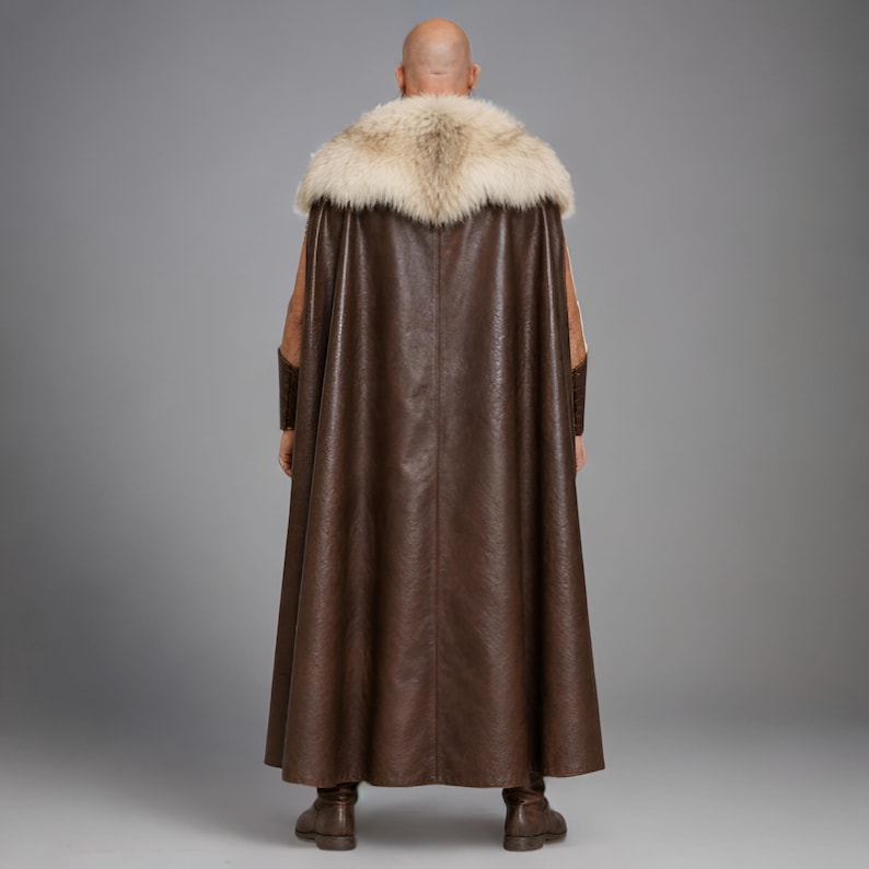 Men’s brown Viking leather tunic with a full-length matching cloak, large light fur shoulder collar, lace-up neckline, wide leather belt, front utility pockets, and matching leather forearm bracers. Front and back views show the sleeveless Norse warrior tunic and long flowing fur-trimmed cloak. Ideal for Viking cosplay, medieval LARP, Renaissance fairs, Halloween, fantasy conventions, stage costumes, and Norse warrior events.