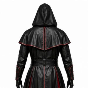 Black leather gothic priest costume with a deep hood, red-lined flowing cloak, structured front leather panels, cross-inspired detailing, wide waist belt, matching leather arm guards, and long sleeves. Dark medieval fantasy outfit designed for Halloween, gothic cosplay, LARP, horror events, conventions, theatrical performances, themed parties, and photoshoots. Handmade leather costume with custom sizing and customization options available.