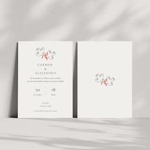 May include: Wedding invitation with a minimalist design. It features two doves and a red bow. The invitation includes the names "CARMEN & ALEJANDRO" and event details in Spanish. The background is a soft, off-white colour.