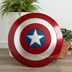 Captain America shield wall decor with red, white and blue concentric rings and silver star center, handmade metal superhero shield inspired wall art, modern home decor, Marvel fan collectible display piece