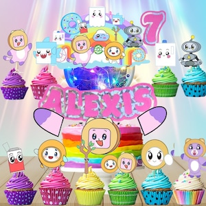 May include: A colorful birthday cake with a rainbow layer design, topped with cartoon character decorations, the number 7, and the name "Alexis". Surrounding the cake are cupcakes with matching character toppers, in various colors.