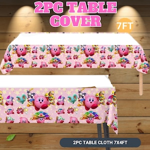 May include: Pink table cover featuring a repeating pattern of a pink character with a star background. The text "2PC TABLE COVER" is at the top, and "7FT" is to the right. The bottom of the image reads "2PC TABLE CLOTH 7X4FT".