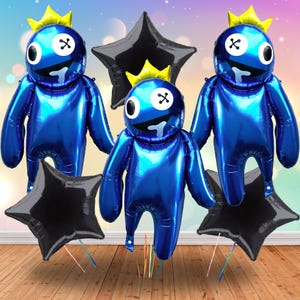 May include: Blue foil balloons shaped like cartoon characters with yellow crowns and black star-shaped balloons. The cartoon characters have white eyes with black X's and a smiling mouth. Party decorations.