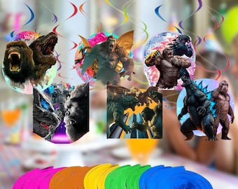 May include: A collection of colorful, circular decorations featuring images of Godzilla and King Kong. The decorations are in various colors and are suspended from the ceiling with colorful streamers. The decorations are suitable for a party.