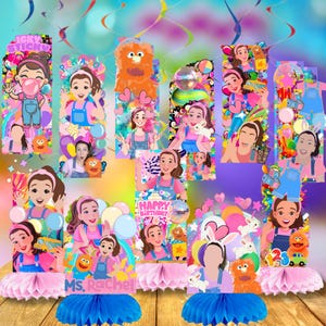 May include: Colorful birthday party decorations featuring cartoon illustrations of a woman in a pink shirt and blue overalls. The decorations include the text "Happy Birthday" and "Ms. Rachel", along with various cartoon characters and balloons.
