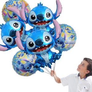 May include: A cluster of blue foil balloons shaped like the character Stitch, with pink ears and a wide grin. Several round balloons with Stitch graphics are also present. The balloons are held by a person.