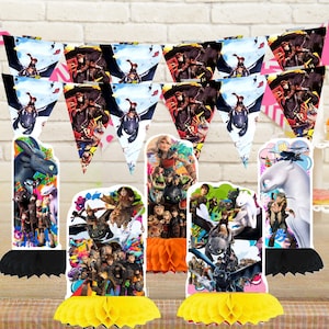 May include: A collection of party decorations featuring characters and scenes from the "How to Train Your Dragon" animated film series. Includes pennant banners, table centerpieces, and decorative cutouts with vibrant colors and detailed illustrations.