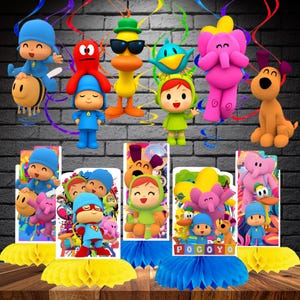 May include: A collection of Pocoyo-themed party decorations featuring 3D character cutouts of Pocoyo, Pato, Elly, and Nina, along with colorful honeycomb paper bases in yellow and blue, and rectangular centerpieces displaying the characters.