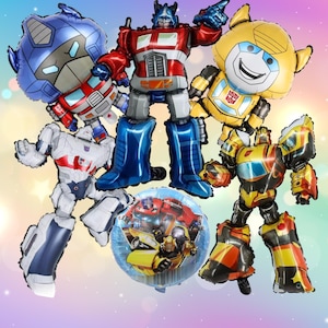 May include: A collection of colorful foil balloons shaped like Transformers characters. The balloons feature Optimus Prime, Bumblebee, and other Autobots in vibrant red, blue, yellow, and silver colors. Ideal for a birthday party or themed event.