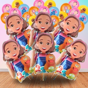 May include: A collection of colorful party balloons featuring a cartoon girl, a furry orange monster, and lettered balloons. The balloons are in various colors, including pink, yellow, orange, and blue, perfect for a birthday celebration.