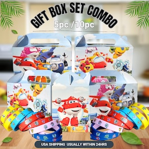 May include: Gift box set combo featuring colorful cartoon character designs. The set includes multiple boxes and matching wristbands. The boxes have a handle and are decorated with images of airplanes and vehicles. The wristbands are in various colors with character prints.