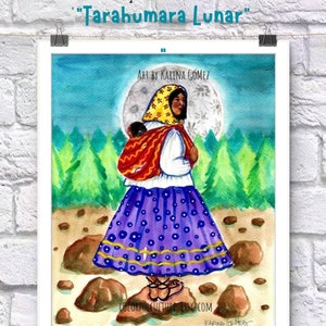 May include: Watercolor painting of a woman wearing a traditional Tarahumara dress and carrying a child on her back. The woman is standing on rocks in a forest with a large, bright moon in the sky. The painting is titled "Tarahumara Lunar" and is by artist Karina Gomez.