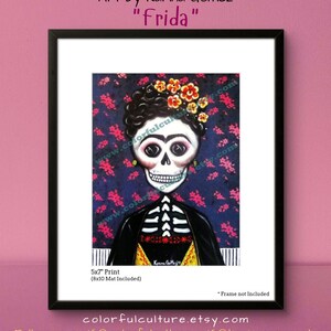 May include: A 5x7 inch print of a colorful illustration of Frida Kahlo as a skeleton with a floral crown. The background is a dark blue with pink and white flowers. The print includes an 8x10 inch mat.
