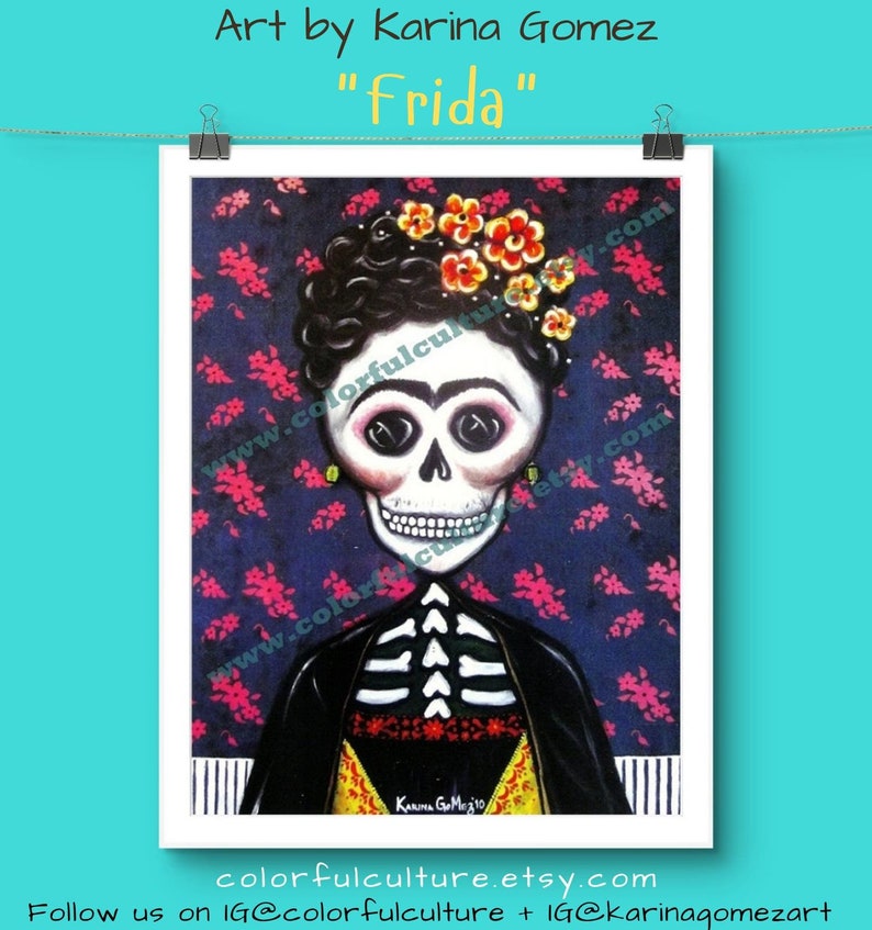 May include: A colorful painting of Frida Kahlo with a sugar skull face, wearing a black jacket and a yellow blouse with a red sash. The background is a dark blue with pink flowers.
