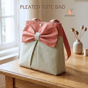 May include: A pleated tote bag featuring a light green and white gingham pattern on the lower section and a solid coral pink upper section with a large decorative bow. The bag includes two shoulder straps and a single gold-tone snap button closure.