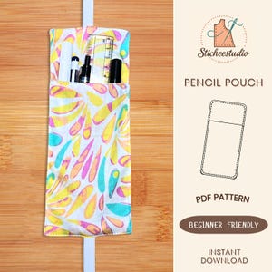 May include: A colorful pencil pouch with a white strap, filled with pens, a ruler, and a marker. The pouch features a pattern of yellow, pink, and teal teardrop shapes on a white background. The text "PENCIL POUCH" and "PDF PATTERN" are visible.
