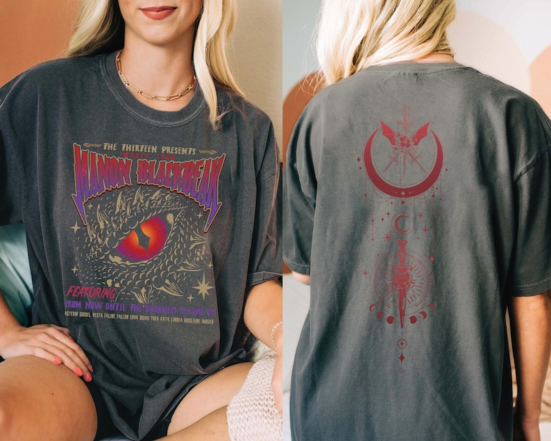 a woman wearing a black t-shirt with a dragon design and text on it.