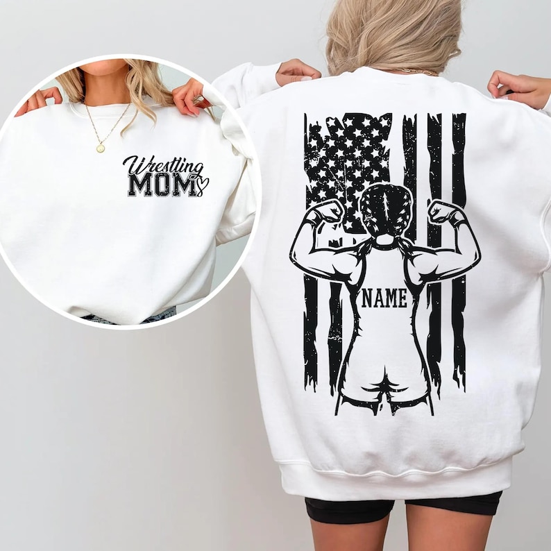 A person wearing a white sweatshirt with a black graphic design on the back, featuring a muscular figure and an American flag.