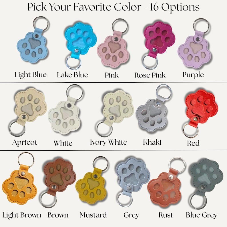 May include: A collection of sixteen paw-shaped keychains in various colors, including light blue, pink, and red. Each keychain has a metal ring and a leather strap. The text "Pick Your Favorite Color - 16 Options" is at the top.
