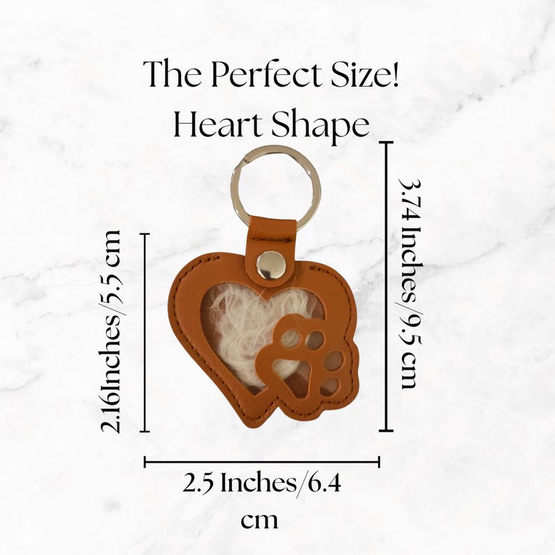 May include: A brown leather heart-shaped keychain with a paw print and a silver key ring. The keychain is 3.74 inches (9.5 cm) tall and 2.5 inches (6.4 cm) wide. The text "The Perfect Size! Heart Shape" is above the keychain.