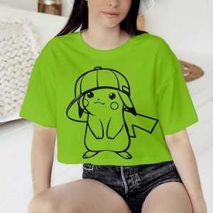 May include: A lime green crop top featuring a black outline illustration of a cartoon character wearing a cap. The person in the image is also wearing a white bucket hat and denim shorts.
