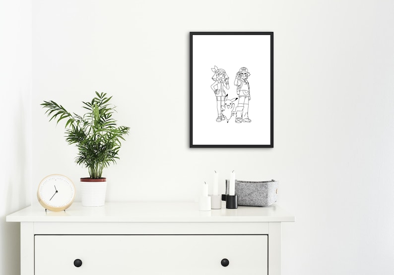 May include: Black framed print featuring a black and white illustration of two cartoon characters and a Pikachu. The artwork is displayed on a white wall above a white dresser. A small potted plant and a clock are on the dresser.