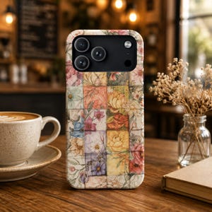 May include: A smartphone case featuring a grid of square tiles, each decorated with watercolour-style floral illustrations in shades of pink, yellow, blue, and orange. The case has a black camera module cutout at the top with three circular lenses.