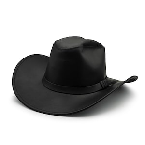 May include: A solid black cowboy hat featuring a structured crown with a central crease and a wide, curved brim. The hat includes a matching black band wrapped around the base of the crown, finished with a small, simple knot detail on the side.