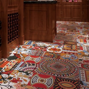 May include: A white ceramic mug with a black handle and the text "But First, Coffee" in a bold, black font. The mug is set against a blurred background, suggesting a cozy setting.