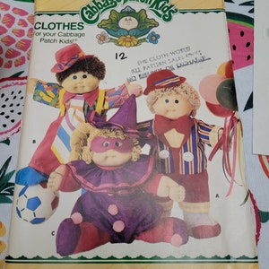 May include: A vintage sewing pattern for Cabbage Patch Kids clothing. The pattern is for size 12 and includes three different outfits: a clown costume, a striped shirt and pants, and a red and yellow outfit. The pattern is from Butterick and has the number 4076 printed on it.