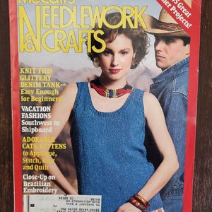 May include: A vintage magazine cover for McCall's Needlework & Crafts, June 1987 issue. The cover features a woman in a blue denim tank top and a man in a denim jacket. Text includes "Knit This Glittery Denim Tank" and "Over 75 Great Summer Projects!"