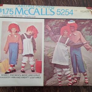 May include: A vintage sewing pattern for Raggedy Ann and Andy costumes. The pattern is from McCall's and is size medium. The pattern cover features illustrations of children dressed as Raggedy Ann and Andy.