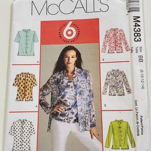 May include: A sewing pattern for a long-sleeved blouse with a mandarin collar. The pattern is for sizes 8-10-12-14 and is called McCall's M4383. The pattern includes three different views of the blouse, each with a different fabric and print.