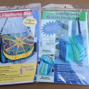 May include: Two bag pattern packets in plastic. The Flaptastic Bag packet features a colorful bag with a flap, measuring 12" wide, 9.5" tall, and 4" deep. The Uptown Saddlebag packet shows a blue and green striped bag, 8" wide, 6" deep, and 9" tall.