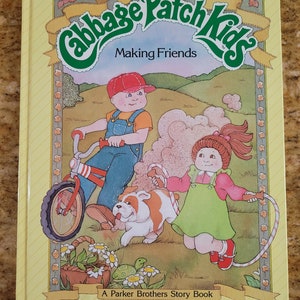 May include: A Cabbage Patch Kids book titled "Making Friends" featuring a boy riding a red and white bicycle, a girl jumping rope, and a brown and white bulldog. The book cover is yellow with a green and yellow title.