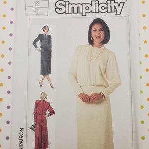 May include: Simplicity sewing pattern number 7164 for a dress. The pattern includes two different styles, one with a skirt that falls to the knee and another with a longer skirt. The pattern is for sizes 12 and 40.
