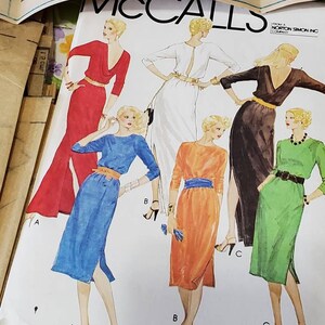 May include: A sewing pattern for a long or short dress with a low back. The pattern shows four different styles of the dress in red, blue, orange, and green.