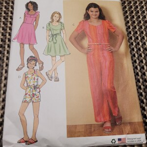 May include: Butterick sewing pattern B6888 featuring illustrations of girls' dresses and a jumpsuit. The pattern includes a pink dress, a green dress, a fruit-patterned romper, and a striped jumpsuit. The pattern is designed and printed in the USA.