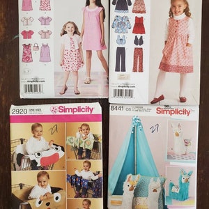 May include: Four different sewing patterns for children's clothing and accessories. The patterns are from Simplicity and include a dress, a vest, pants, a play tent, and a llama pillow. The patterns are for sizes HH 3, 4.5, 8, A 3, 4, 5, 6, 7, 8, OS, and 90s.
