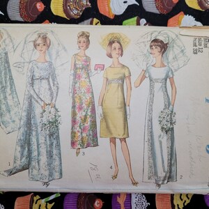 May include: Vintage Simplicity sewing pattern #352 for a wedding dress. The pattern includes four different styles of dresses, all with long sleeves and a variety of necklines. The pattern is for sizes 12 and 18.