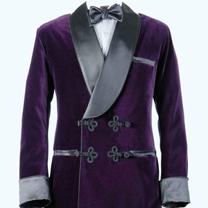 May include: A formal purple velvet jacket with a black satin shawl collar, cuffs, and trim. The jacket features four ornate black frog closures and a matching bow tie. The jacket is a formal wear item.