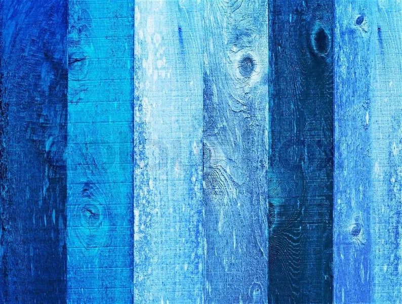 May include: A close-up of a wooden surface with vertical planks in varying shades of blue. The planks have visible wood grain and knots, creating a textured and rustic appearance. The color palette ranges from deep navy to light sky blue.