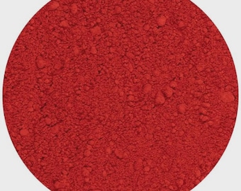 May include: A close-up of a vibrant red powder, contained within a circular shape. The powder has a fine, textured appearance, with subtle variations in tone. The overall impression is of a rich, saturated color, suggesting a pigment or dye.