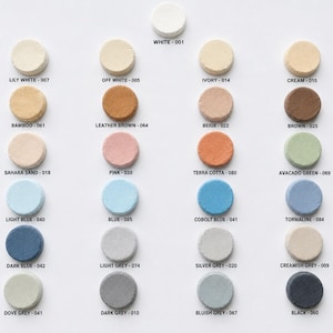 May include: A color chart featuring twenty-four circular samples arranged in columns. Each sample is labeled with a color name and a numerical code, including White-001, Lily White-007, Off White-005, Ivory-014, Cream-015, Bamboo-061, Leather Brown-064, Beige-022, Brown-025, Sahara Sand-018, Pink-030, Terra Cotta-080, Avacado Green-069, Light Blue-040, Blue-085, Cobolt Blue-041, Tormaline-084, Dark Blue-042, Light Grey-074, Silver Grey-020, Creamish Grey-009, Dove Grey-041, Dark Grey-010, Bluish Grey-067, and Black-060.
