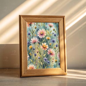 May include: A framed watercolor print featuring a field of colorful wildflowers. The artwork showcases pink, yellow, and purple blooms against a soft blue background. The wooden frame adds a natural touch to the floral art.