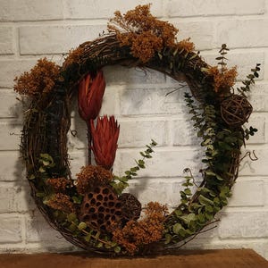 Wreath, door size wreath, preserved florals and natural eucalyptus accents. Grapevine, dried florals, wooden florals, summer & fall colors